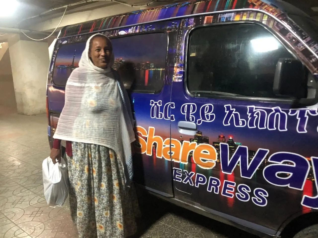 ShareWay Express customer beside a branded delivery vehicle